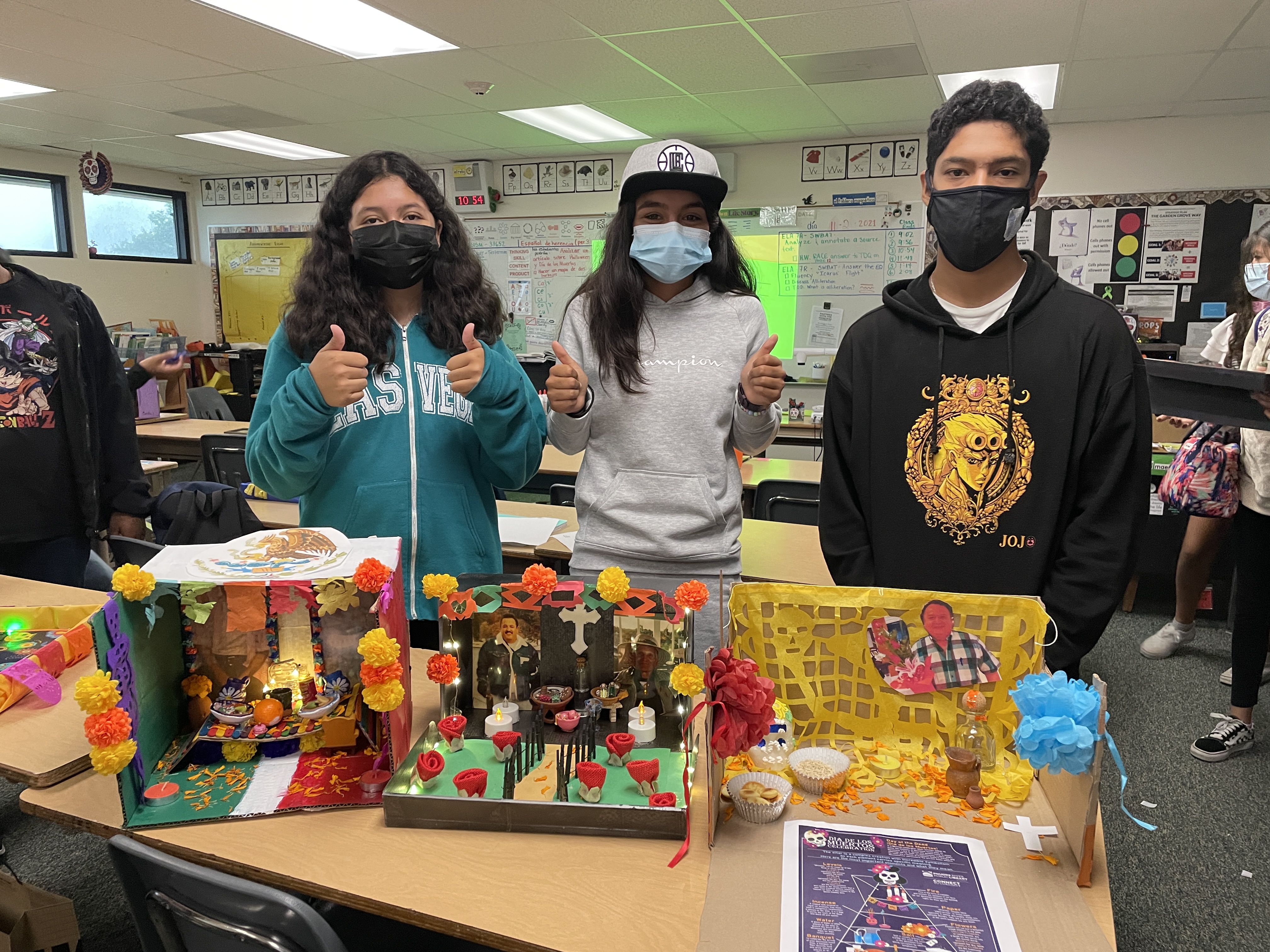 Students showing presenting their beautiful diorama de muertos!
